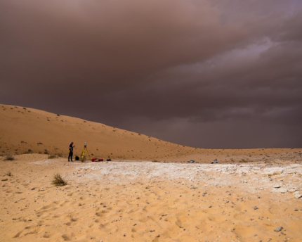 A researcher surveys the Al Wusta site. 